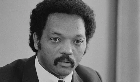 Jesse Jackson civil rights leader speaking at a rally advocating for equality and social justice in 2026